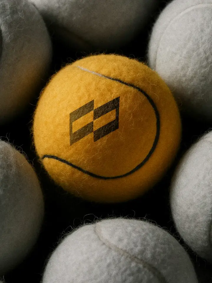 A yellow tennis ball stamped with the Skyrons mark among white ones