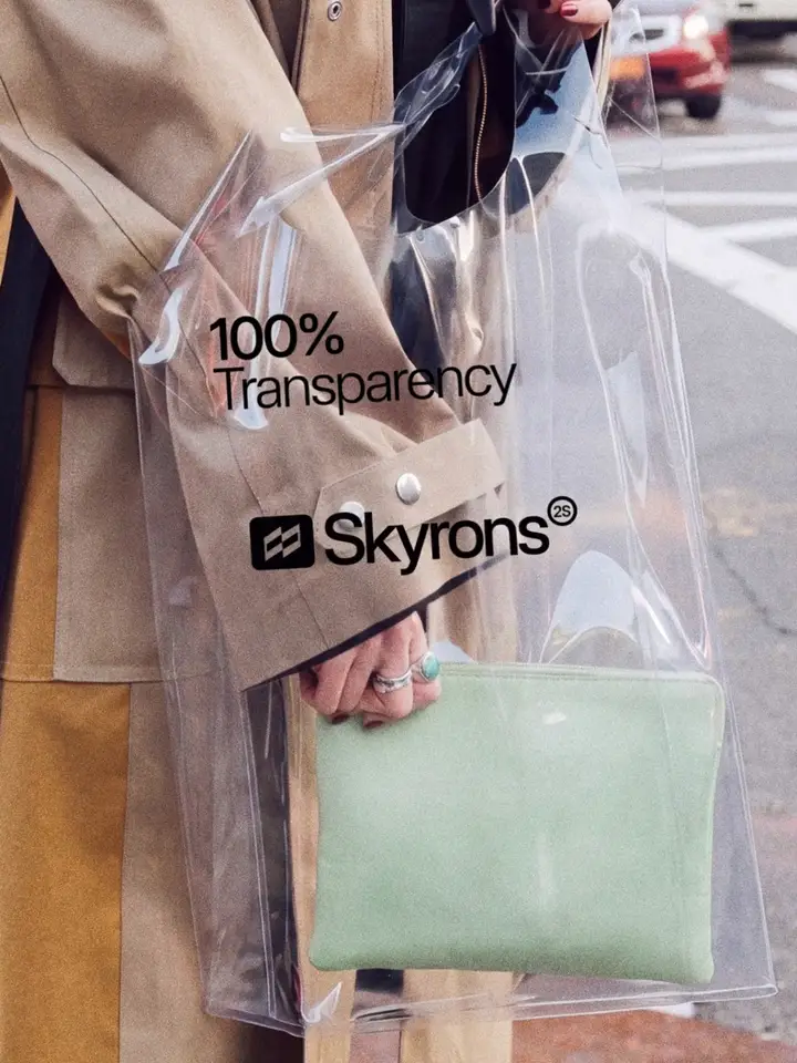 A clear tote bag printed with the Skyrons wordmark, carried on a city street